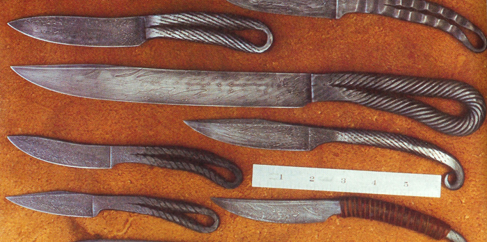 A collection one-piece of cable damascus knives; the four at left are of the variety which interests me.  They feature one piece construction by forging from steel cable, which has been doubled over to form the handle, where it is still identifiable as cable.