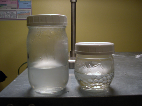 Jars containing first and second fractions, left, and third fraction, right.  Note cloudiness in first two fractions and clarity in third, indicating complete extraction.